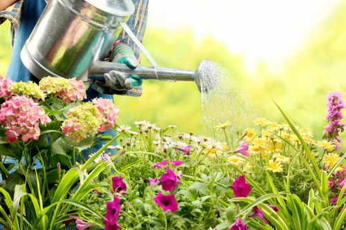 Team managing tools and site hazards during garden work
